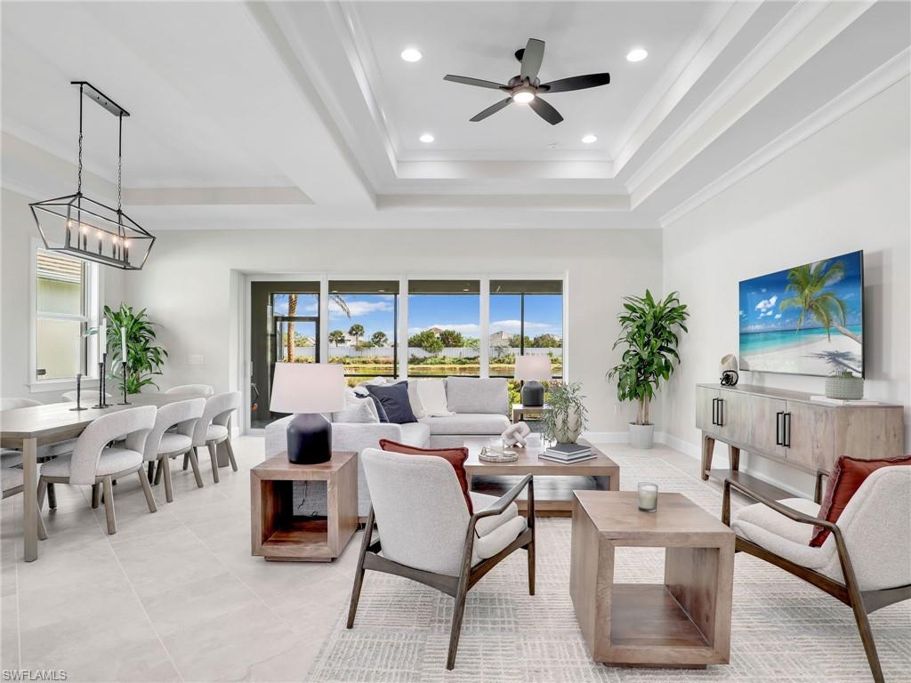 8850 Calypso Court Naples, FL 34113 - Photo 5 of 49 a living room with furniture a dining table and a potted plant