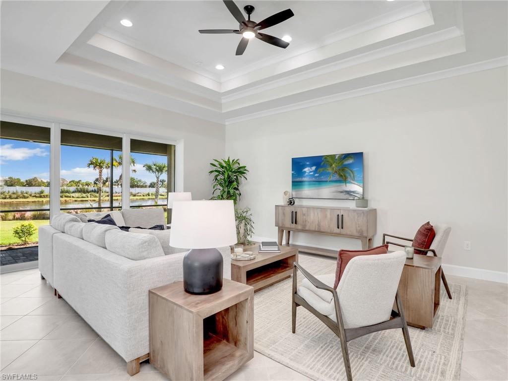 8850 Calypso Court Naples, FL 34113 - Photo 6 of 49 a living room with furniture and a large window