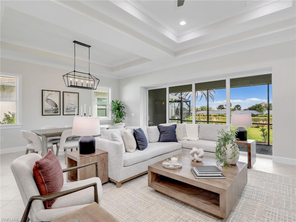 8850 Calypso Court Naples, FL 34113 - Photo 7 of 49 a living room with furniture and a large window