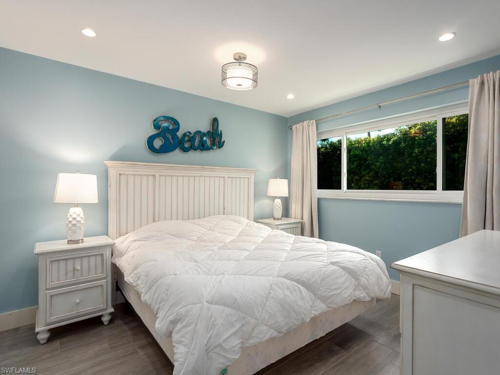 595 Wedge Drive Naples, FL 34103 - Photo 14 of 17 a bedroom with a bed and a window