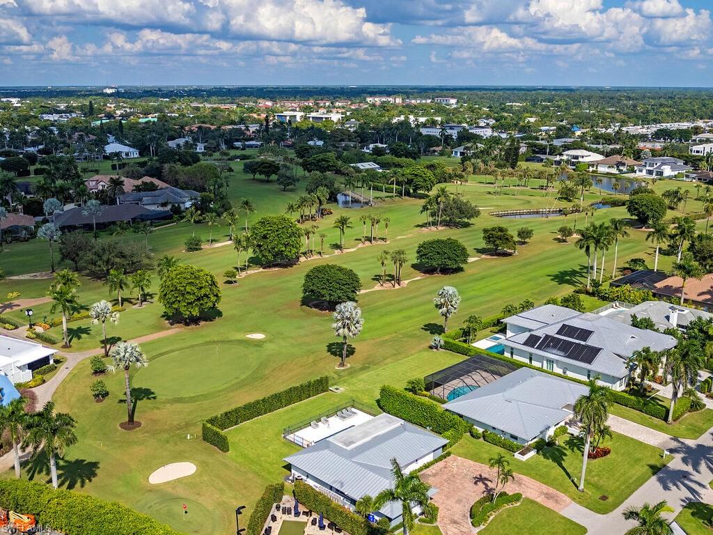 595 Wedge Drive Naples, FL 34103 - Photo 2 of 17 an aerial view of residential houses with outdoor space