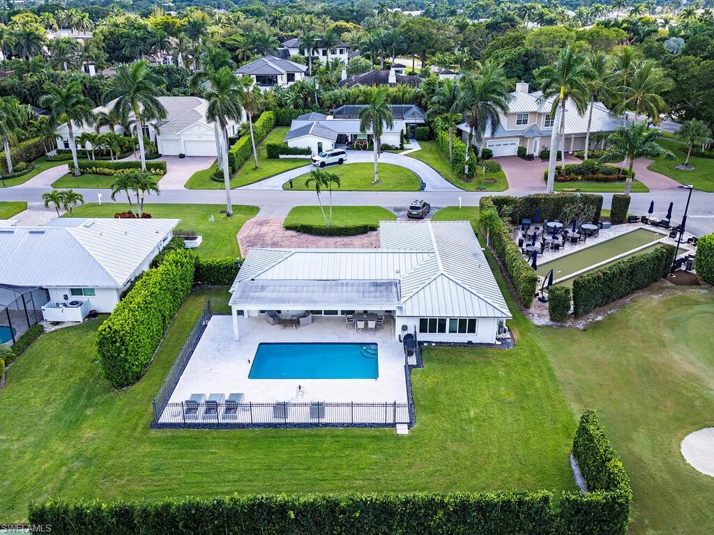 595 Wedge Drive Naples, FL 34103 - Photo 4 of 17 an aerial view of a house with swimming pool yard and outdoor seating