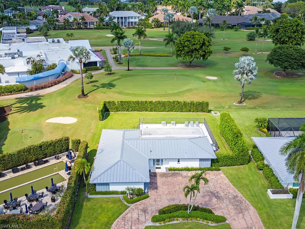 595 Wedge Drive Naples, FL 34103 - Photo 5 of 17 an aerial view of a swimming pool with a yard