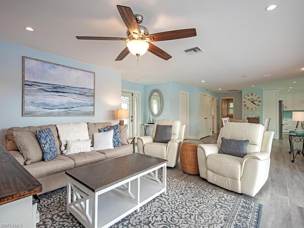595 Wedge Drive Naples, FL 34103 - Photo 7 of 17 a living room with furniture and a chandelier