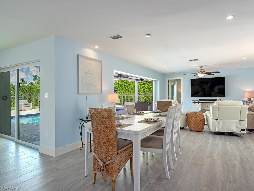 595 Wedge Drive Naples, FL 34103 - Photo 8 of 17 a view of a dining room with furniture window and wooden floor