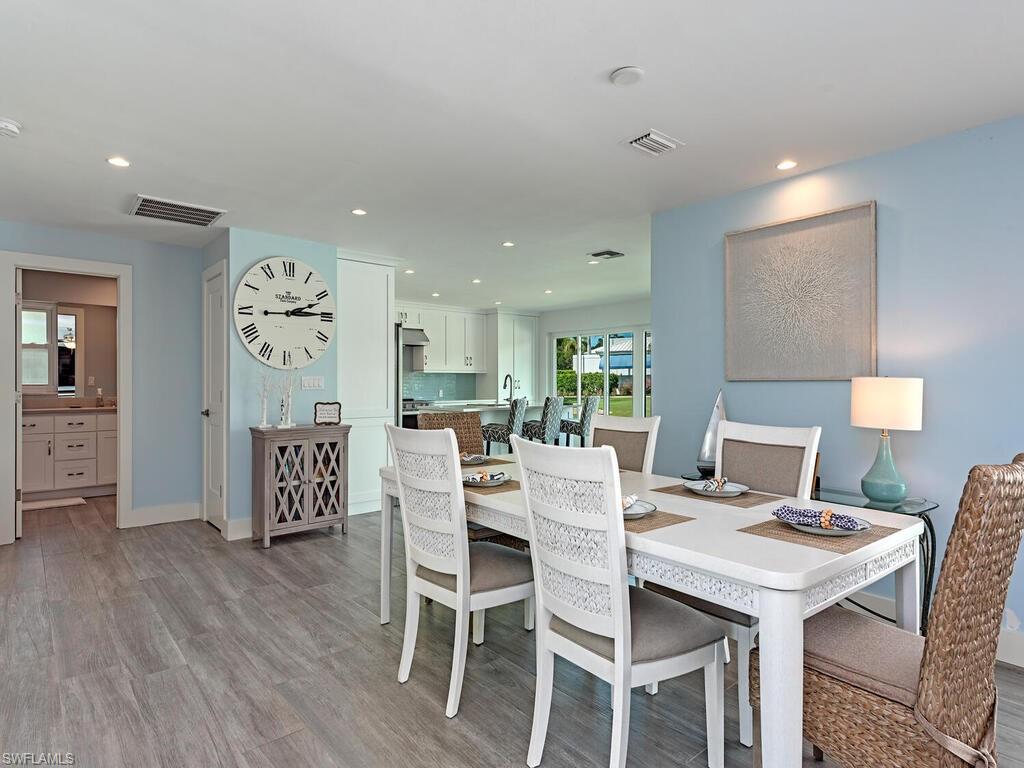 595 Wedge Drive Naples, FL 34103 - Photo 9 of 17 a view of a dining room with furniture and wooden floor