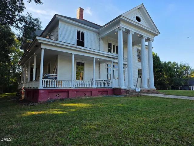 a view of pool with a yard in front of it