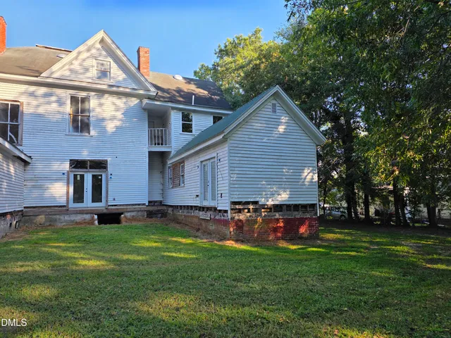a front view of house with a garden