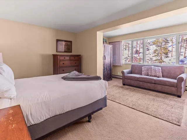 a bedroom with a bed and flat screen tv