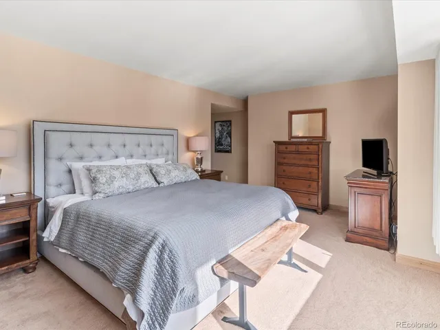 a bathroom with a granite countertop sink a toilet and a mirror