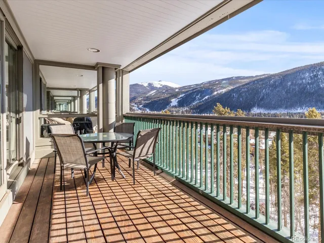 a view of a chairs and table in the balcony