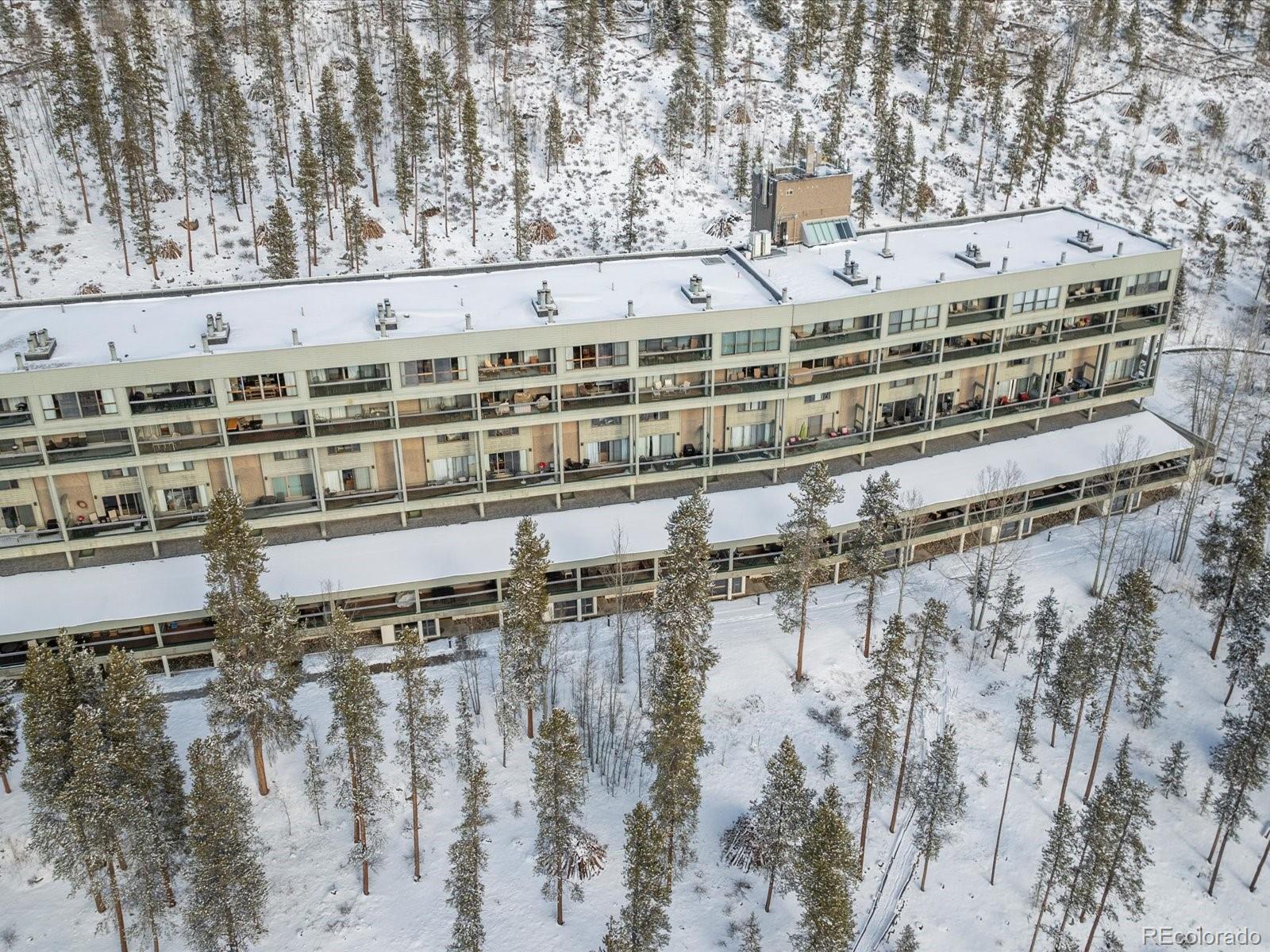 22097 Saints John Road, Unit 2540 Dillon, CO 80435 - Photo 23 of 28 a large building sitting on top of a lake
