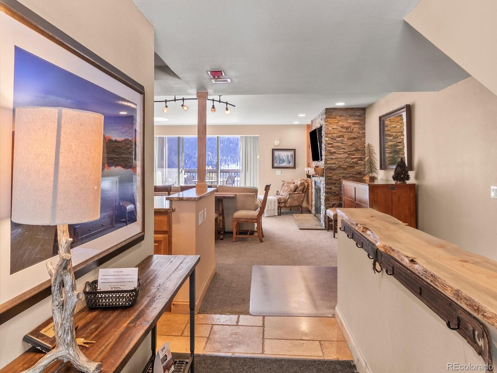 22097 Saints John Road, Unit 2540 Dillon, CO 80435 - Photo 4 of 28 a room with stainless steel appliances kitchen island granite countertop furniture and a view of living room