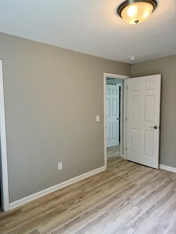 a view of an empty room and wooden floor