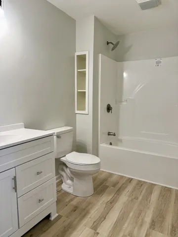 a bathroom with a toilet a sink and bathtub