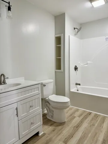 a bathroom with a toilet a sink and bathtub