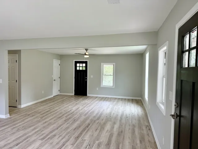 wooden floor in an empty room with a window