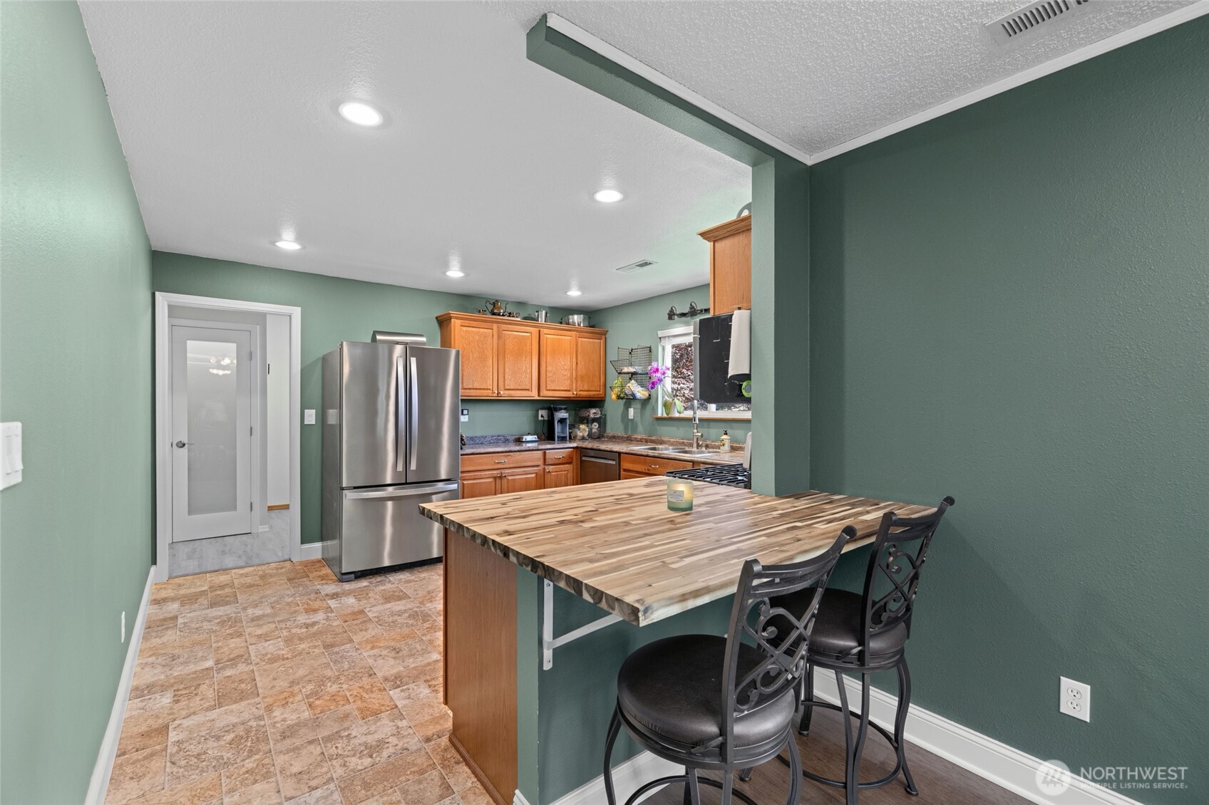 415 Sterling Street Sedro-Woolley, WA 98284 - Photo 16 of 38 a kitchen with stainless steel appliances granite countertop a table chairs sink and stove