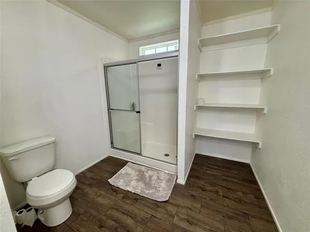 a bedroom with a bed and a mirror