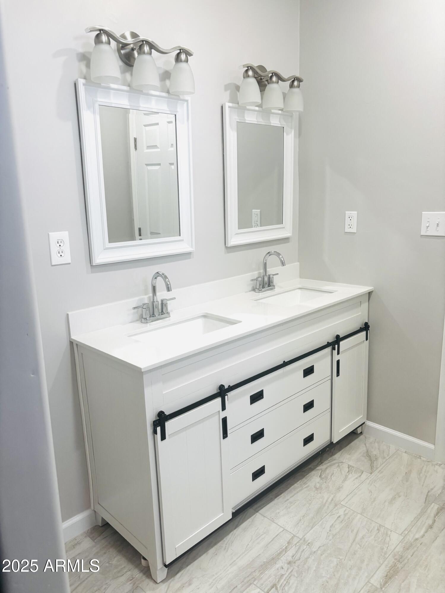 3440 Camino Del Rancho Douglas, AZ 85607 - Photo 13 of 17 a bathroom with a double vanity sink and mirror