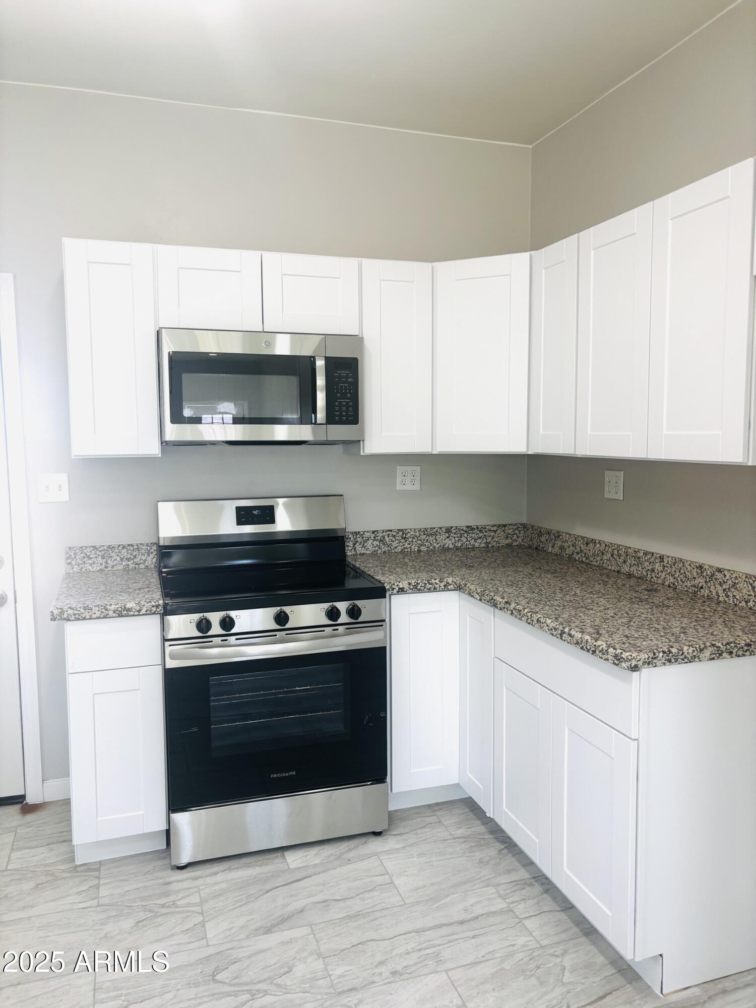 3440 Camino Del Rancho Douglas, AZ 85607 - Photo 4 of 17 a kitchen with stainless steel appliances granite countertop a stove microwave and cabinets