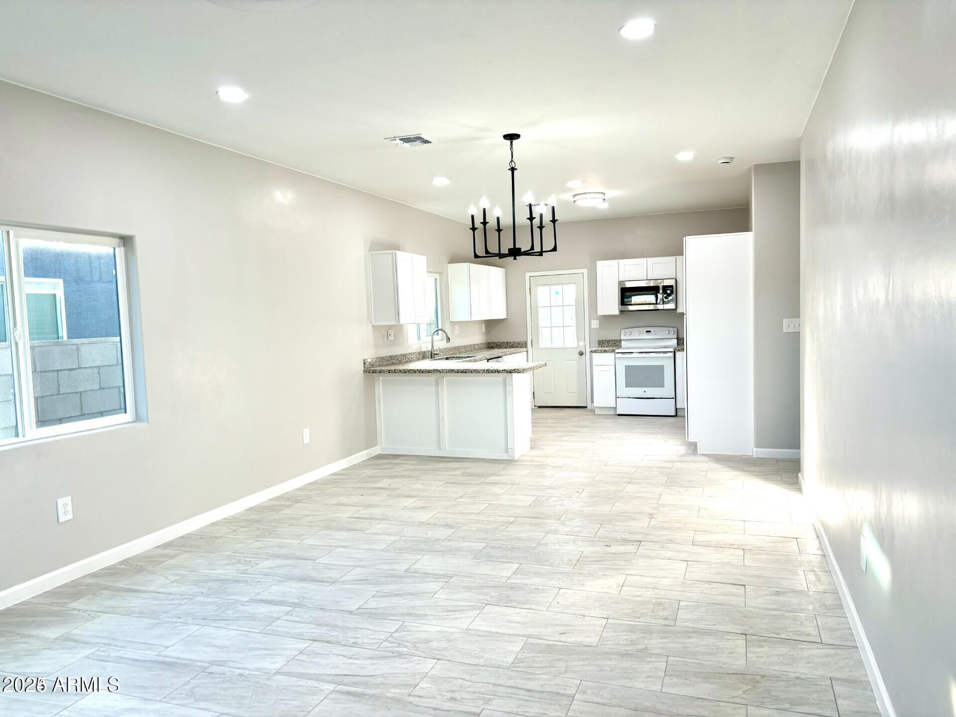 3440 Camino Del Rancho Douglas, AZ 85607 - Photo 5 of 17 a view of a kitchen with a sink and cabinets