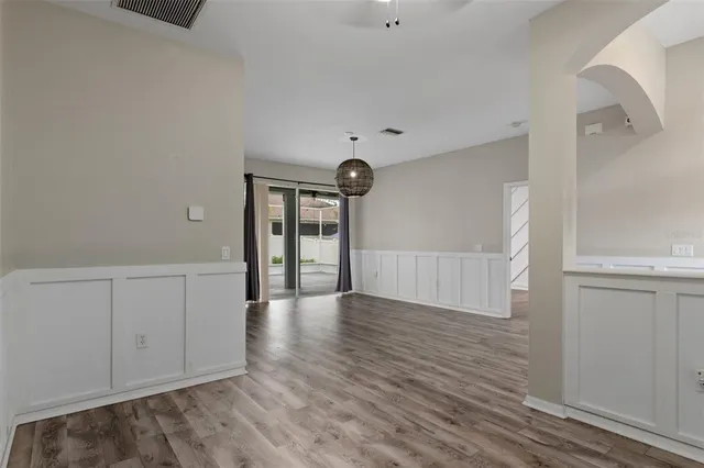 a kitchen with granite countertop white cabinets and stainless steel appliances