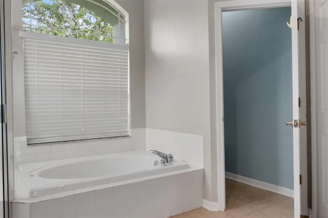 a bathroom with a shower and a bath tub