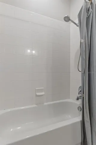 a living room with furniture and a ceiling fan