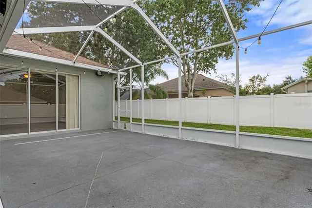 a view of a patio with couches chairs under an umbrella