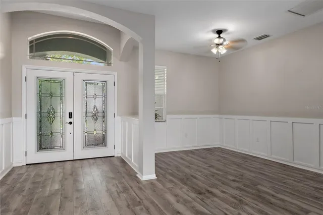 wooden floor in an empty room with a window