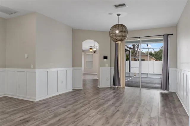 a view of a room with wooden floor