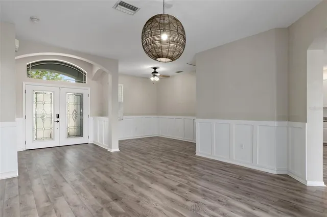 a kitchen with granite countertop a refrigerator stove and sink