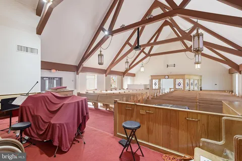 a view of a dining room with furniture a chandelier and wooden floor