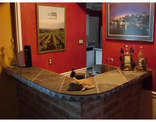 a room with table chairs and painting on the wall