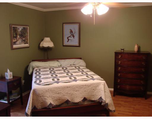 206 Seco Drive Portland, TX 78374 - Photo 7 of 10 a bedroom with a bed and a chandelier