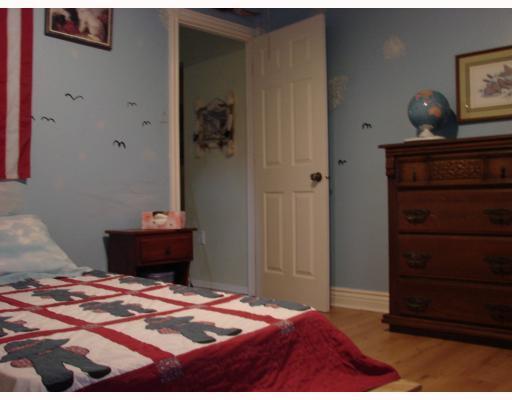 206 Seco Drive Portland, TX 78374 - Photo 8 of 10 a bedroom with a bed and a dresser