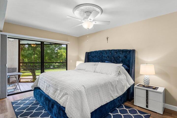 10110 Cedar Point Boulevard, Unit 203 Boynton Beach, FL 33437 - Photo 11 of 37 a bedroom with a large bed and a large window
