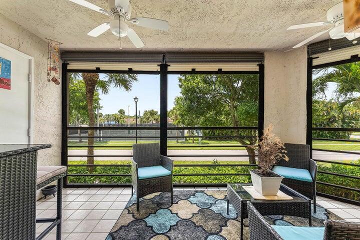 10110 Cedar Point Boulevard, Unit 203 Boynton Beach, FL 33437 - Photo 16 of 37 a living room with large windows