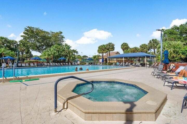 10110 Cedar Point Boulevard, Unit 203 Boynton Beach, FL 33437 - Photo 20 of 37 a swimming pool with outdoor seating and yard