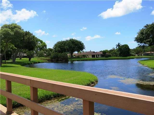 10110 Cedar Point Boulevard, Unit 203 Boynton Beach, FL 33437 - Photo 21 of 37 a view of a lake with a yard