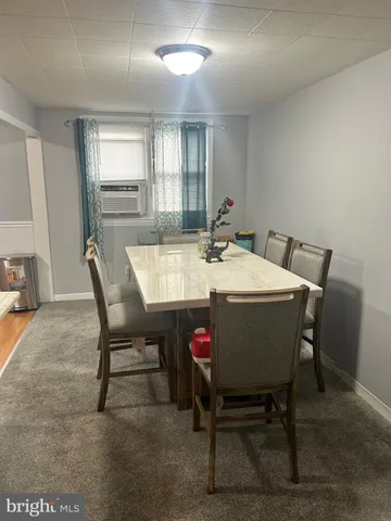 a view of a dining room with furniture and window