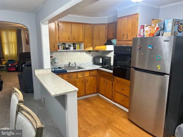 a kitchen with a sink appliances and cabinets