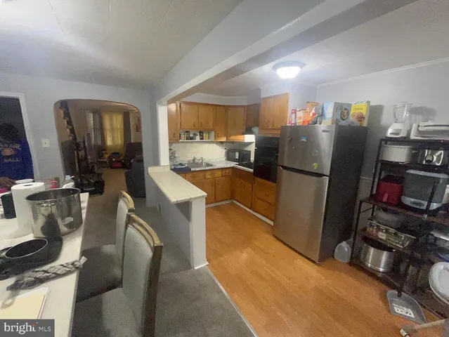 a kitchen with stainless steel appliances granite countertop a refrigerator and a sink