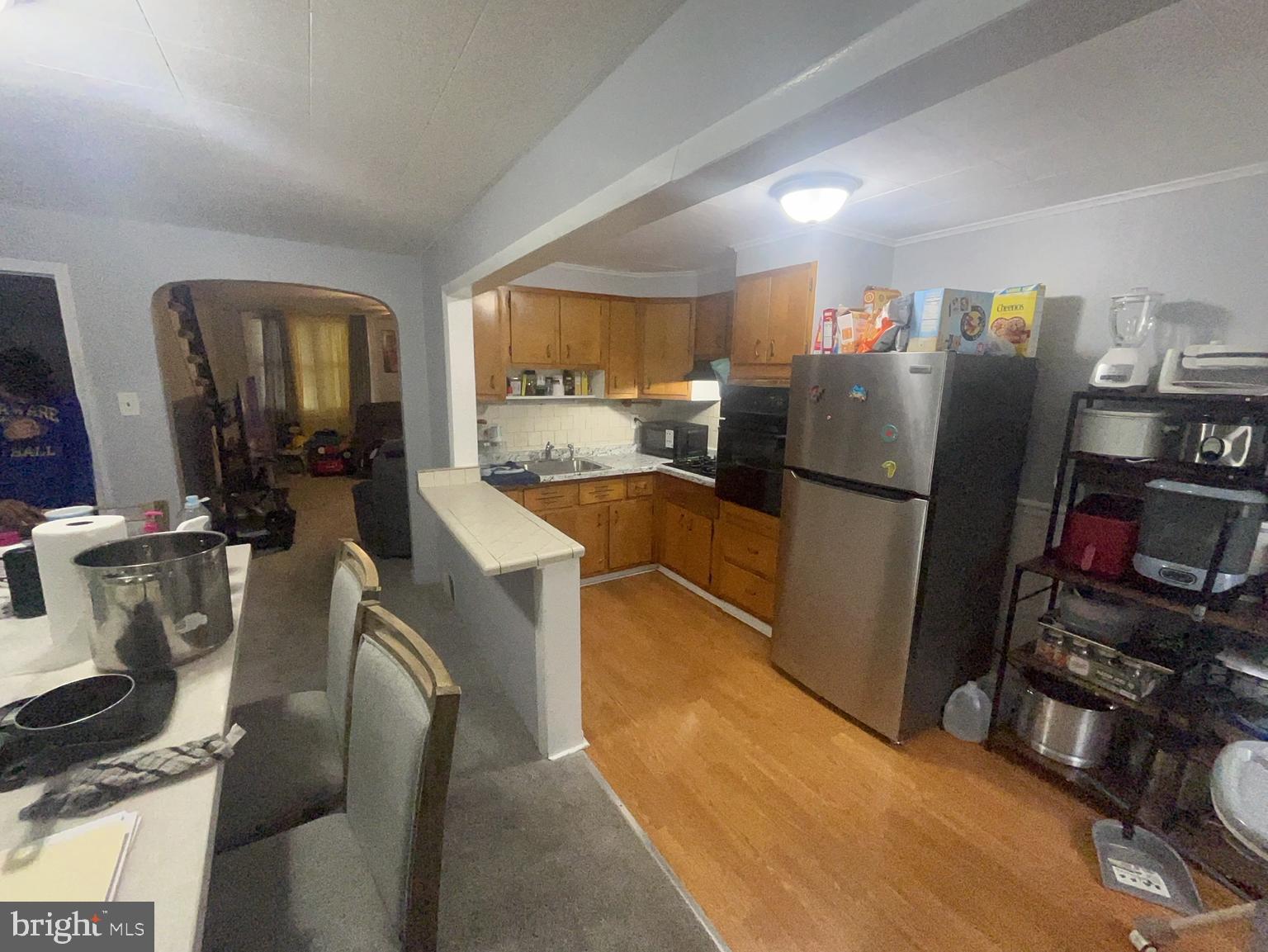 306 Golf Road Darby, PA 19023 - Photo 9 of 14 a kitchen with stainless steel appliances granite countertop a refrigerator and a sink