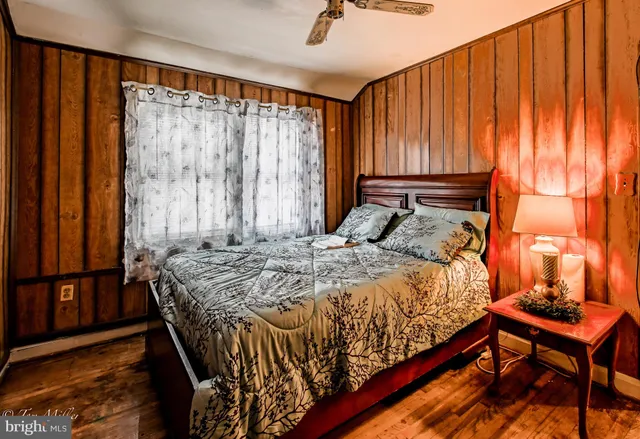 a bedroom with a bed and a curtain