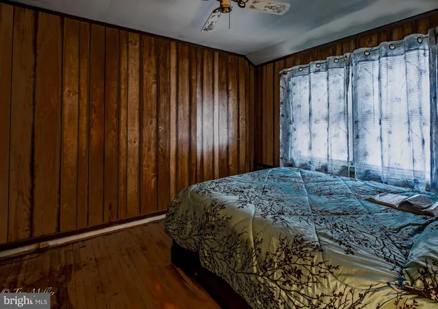 a bedroom with a bed dresser and a window