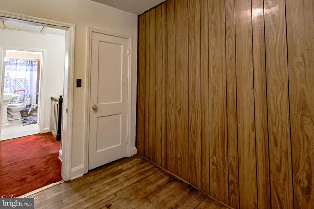 a room with wooden floor and gym equipment