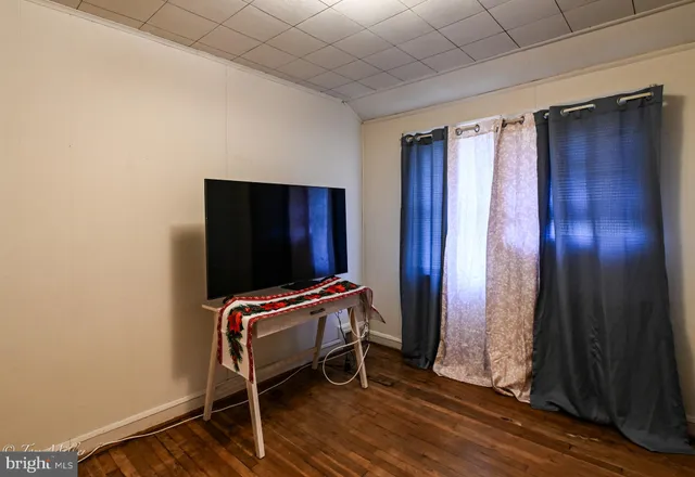 a view of a room with wooden floor