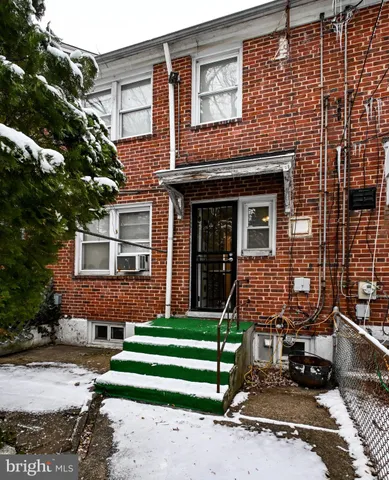 a view of a street with a house in the background